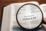 title page book of jonah close up using magnifying glass in the bible or Torah for faith, christian, hebrew, israelite, history, religion, christianity, Old Testament