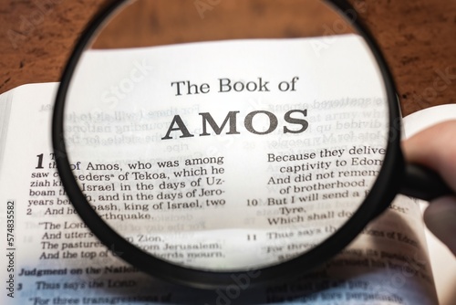 title page book of amos close up using magnifying glass in the bible or Torah for faith, christian, hebrew, israelite, history, religion, christianity, Old Testament photo