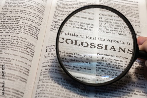 title page book of Colossians close up using magnifying glass in the bible for faith, christian, hebrew, israelite, history, religion, christianity, new testament