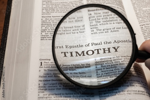 title page book of Timothy close up using magnifying glass in the bible for faith, christian, hebrew, israelite, history, religion, christianity, new testament