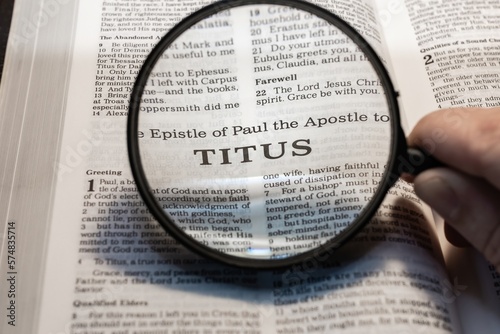 Fotografie, Obraz title page book of Titus close up using magnifying glass in the bible for faith,