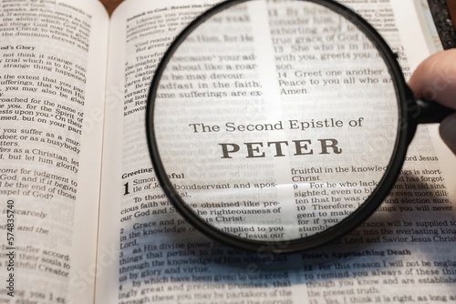 title page book of second Peter close up using magnifying glass in the bible for faith, christian, hebrew, israelite, history, religion, christianity, new testament