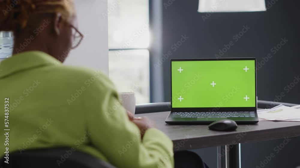 Business manager looking at pc with green screen, using isolated mockup display in agency office. Corporate employee checking chroma key copyspace template at executive startup job. Business manager looking at pc with green screen, using isolated mockup display in agency office. Corporate employee checking chroma key copyspace template at executive startup job.