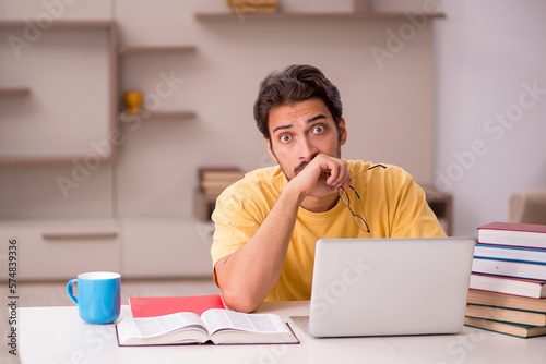 Young male student preparing for exams at home © Elnur