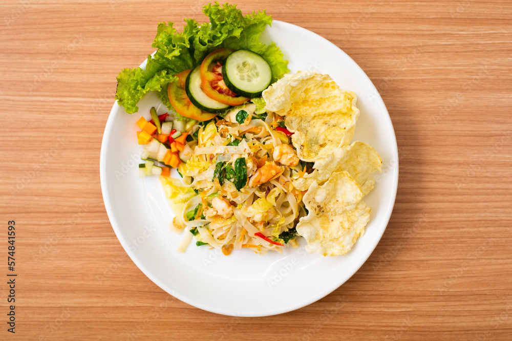A Plate of vegetable salad served with indonesian crisps A Plate of vegetable salad served with indonesian crisps