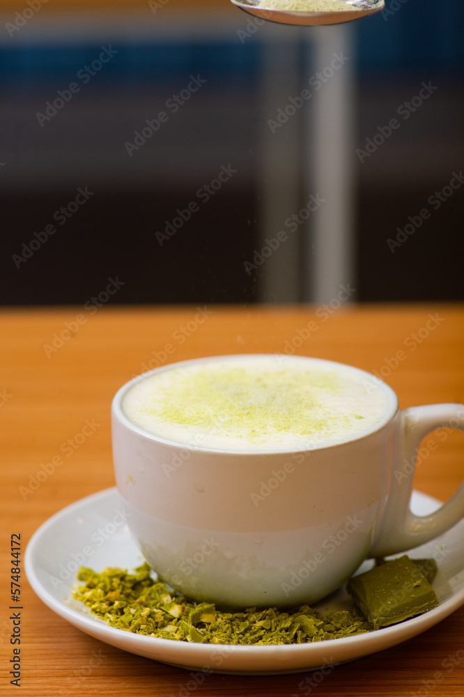 A Glass of matcha drink, served with crumble of matcha chocolate. Sprinkled with matcha powder A Glass of matcha drink, served with crumble of matcha chocolate. Sprinkled with matcha powder