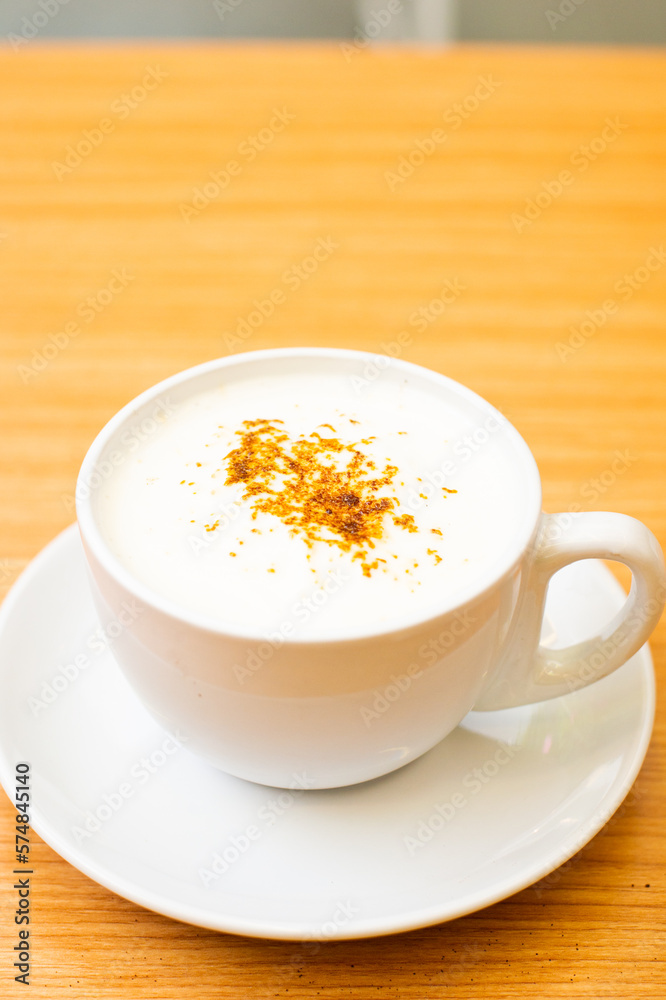A Glass of cappucino coffee, sprinkled with coffee powder on top of the foam A Glass of cappucino coffee, sprinkled with coffee powder on top of the foam