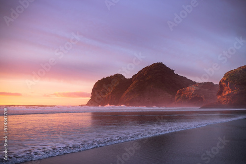 Purple skies and gentle waves at Bethells Beach, New Zealand. (ID: 574847709)