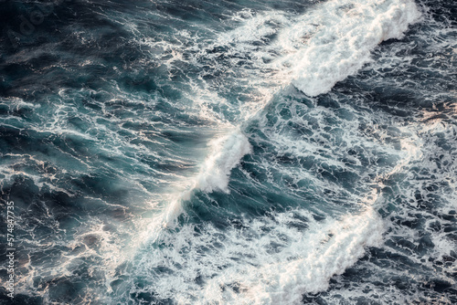 Powerful ocean waves rushing to meet the coastline. (ID: 574847735)