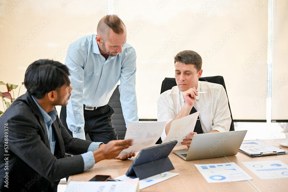 Group of diverse businesspeople are in the meeting together, having a serious conversation Group of diverse businesspeople are in the meeting together, having a serious conversation