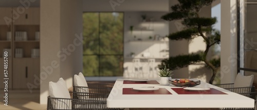 Side view of modern dining room with dining table with beautiful table setting and armchairs