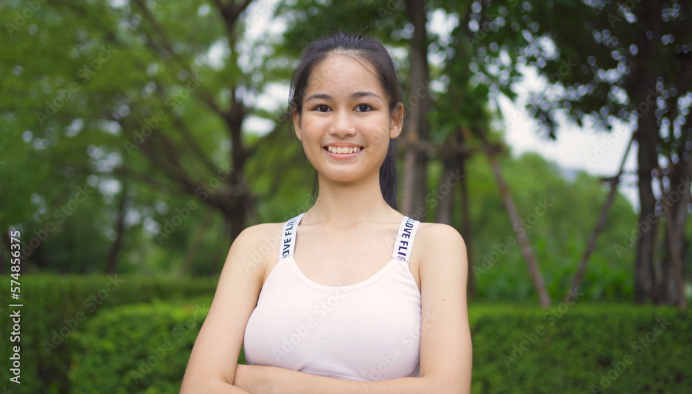 Portrait of Asian woman girl in yoga class club doing exercise, runing or jogging at public garden park. Outdoor sport and recreation. People lifestyle activity with nature trees view. Portrait of Asian woman girl in yoga class club doing exercise, runing or jogging at public garden park. Outdoor sport and recreation. People lifestyle activity with nature trees view.