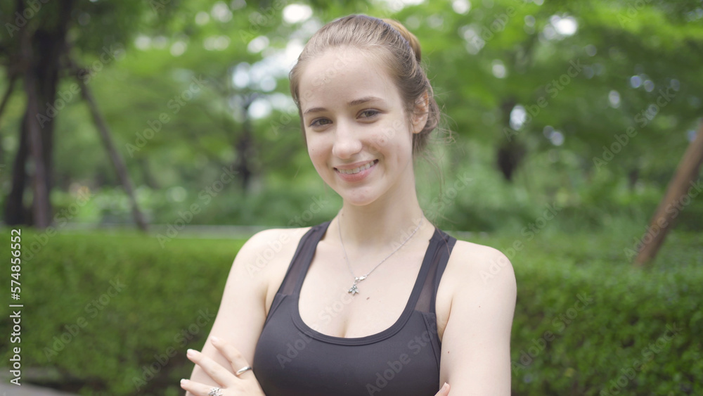 Portrait of Caucasian woman girl in yoga class club doing exercise, runing or jogging at public garden park. Outdoor sport and recreation. People lifestyle activity with nature trees view. Portrait of Caucasian woman girl in yoga class club doing exercise, runing or jogging at public garden park. Outdoor sport and recreation. People lifestyle activity with nature trees view.