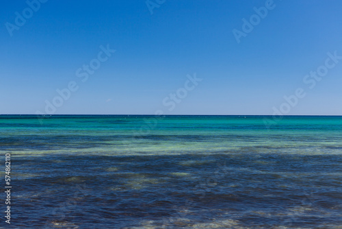Clear and still blue turquoise water of Mediterranean sea with blue sky at Sardinia, Italy.