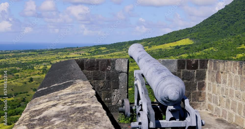 Old historic canon points out from the battlements of Brimstone Hill Fortress, a UNESCO World Heritage site. It is one of the best preserved historical fortifications in the Americas on St. Kitts.