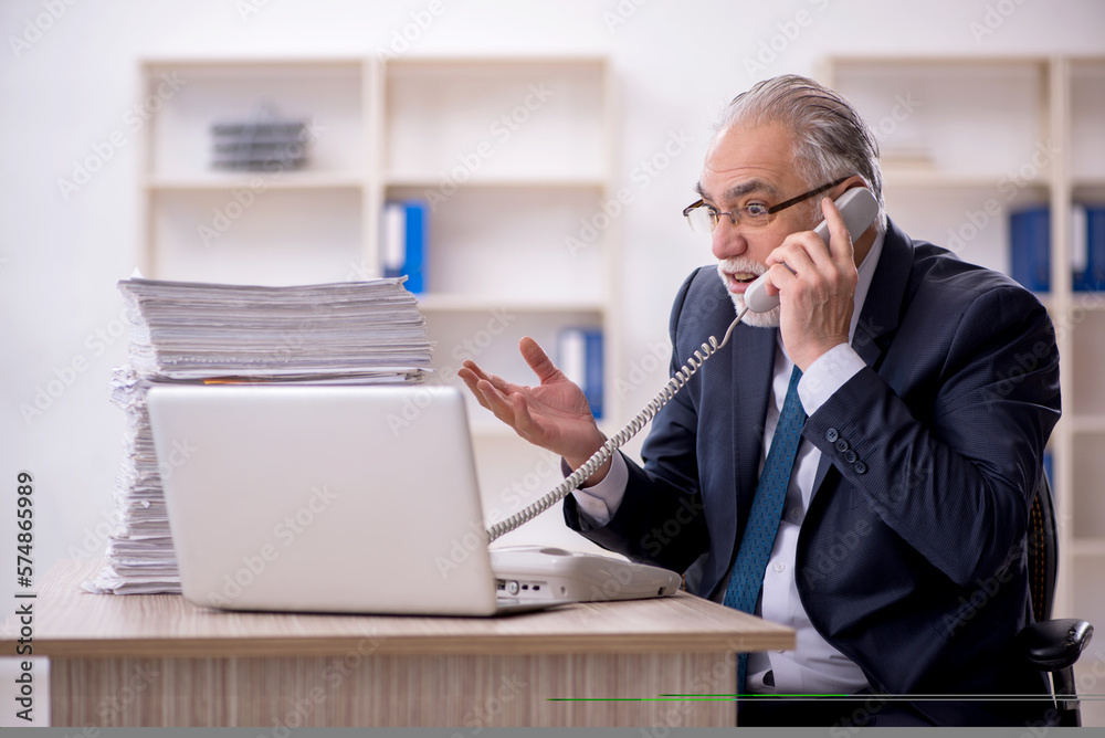 Old male employee and too much work in the office Old male employee and too much work in the office