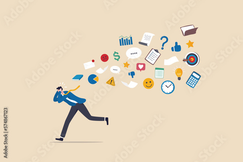 Information overload, excess distraction or overworked, overwhelmed data consume, problem with schedule or workload concept, frustrated businessman run away from flying social and work information. photo