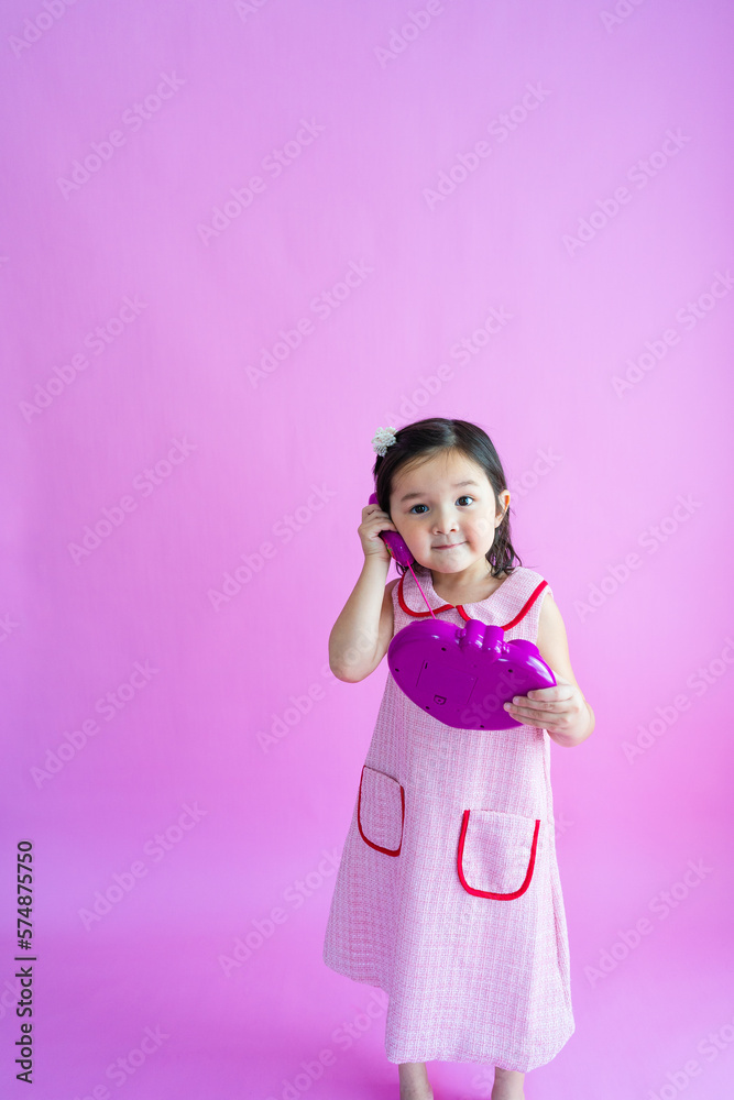 Pretty little girl playing with pretend plastic phone. Pretty little girl playing with pretend plastic phone.