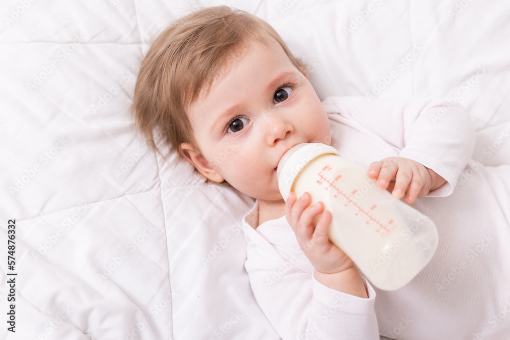 cute baby on blanket with baby bottle, card. space for text, banner cute baby on blanket with baby bottle, card. space for text, banner