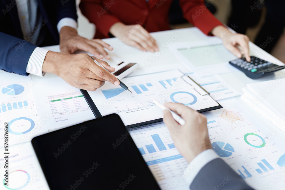 Team business adviser meeting to analyze and discuss the situation on the financial report n the meeting room with using calculator, documents, computer laptop in work. Team business adviser meeting to analyze and discuss the situation on the financial report n the meeting room with using calculator, documents, computer laptop in work.