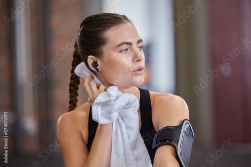 Thinking, tired and woman with towel for sweat in gym after workout, training or exercise. Sports idea, exhausted and sweating female athlete wipe with fabric after exercising, running or cardio.
