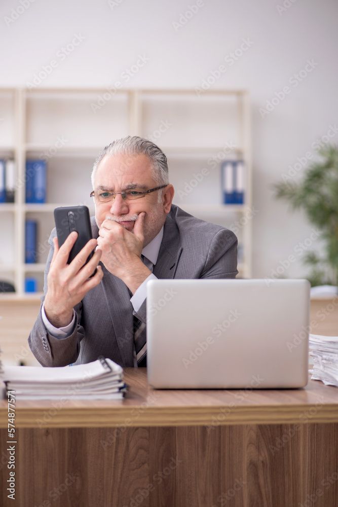 Old male employee and too much work in the office Old male employee and too much work in the office