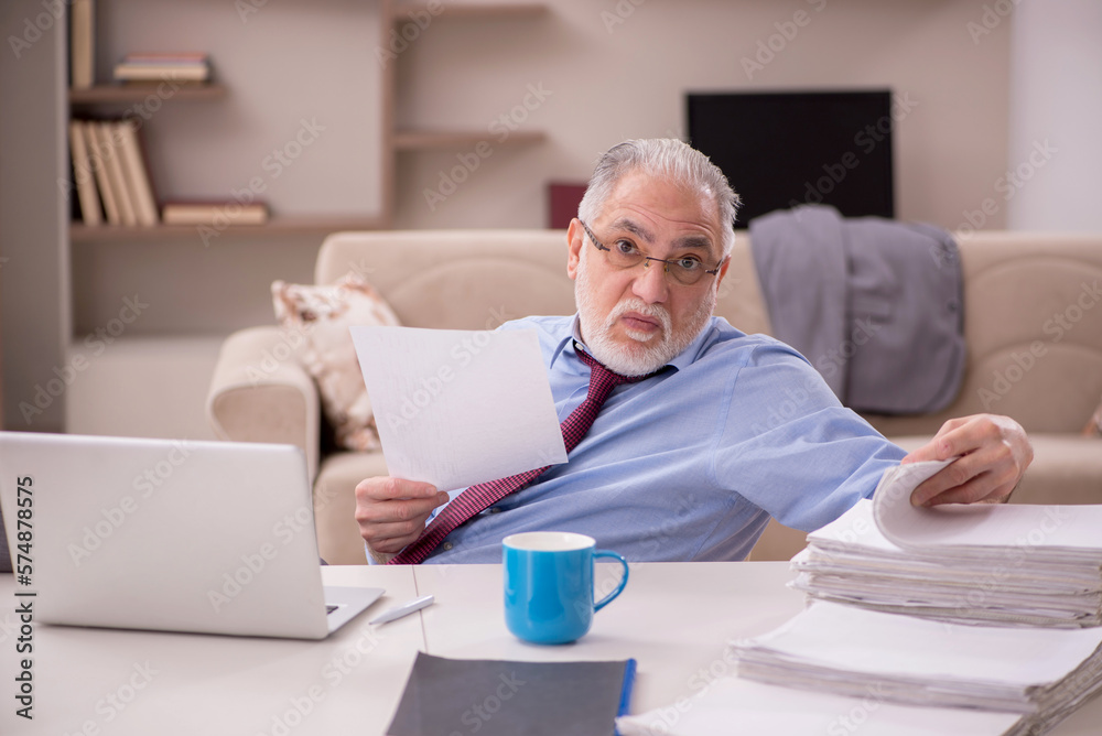 Old male employee working from home during pandemic Old male employee working from home during pandemic