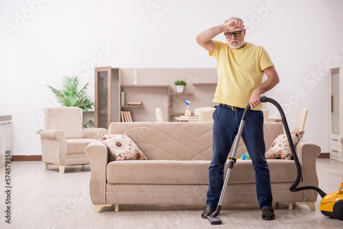 Old man doing housework at home