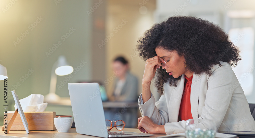 Tired and stressed female with a headache sitting at her desk inside a stylish office or creative startup agency. Exhausted and trendy business woman in pain while typing on a laptop, working late Tired and stressed female with a headache sitting at her desk inside a stylish office or creative startup agency. Exhausted and trendy business woman in pain while typing on a laptop, working late