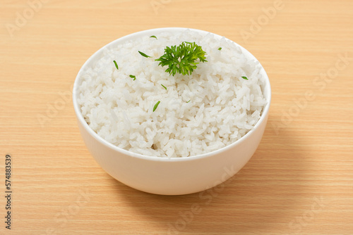 White rice in bowl on wood table