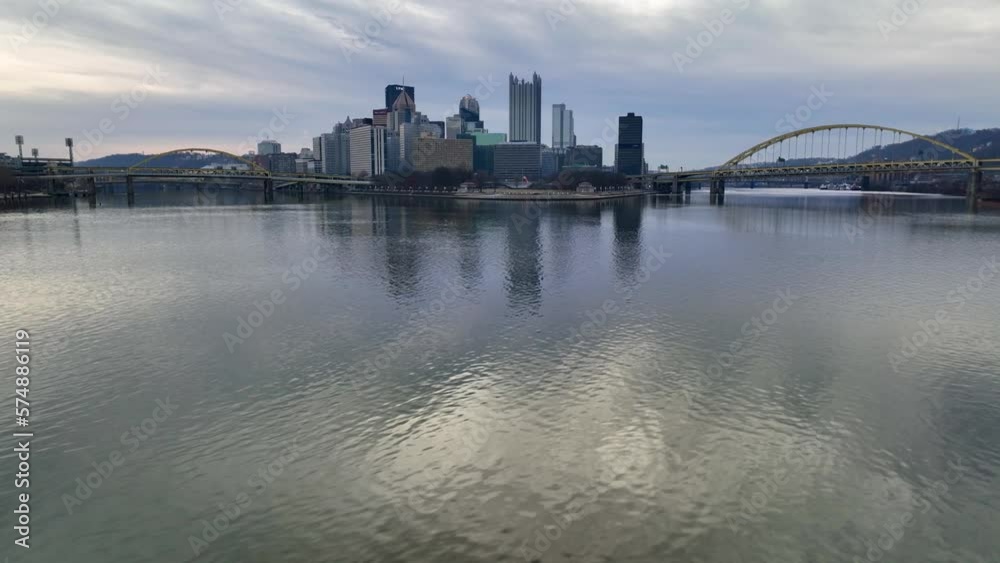 Aerial glide over Ohio River with Pittsburgh skyline, Point State Park, and yellow bridges in background. Aerial glide over Ohio River with Pittsburgh skyline, Point State Park, and yellow bridges in background.