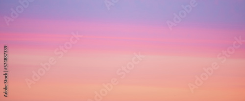 Beautiful backdrop of sunset sky of pink orange lilac violet magenta colors. Colorful smooth dawn sky gradient. Nature background of sunrise. Amazing morning heaven. Slightly cloudy evening atmosphere