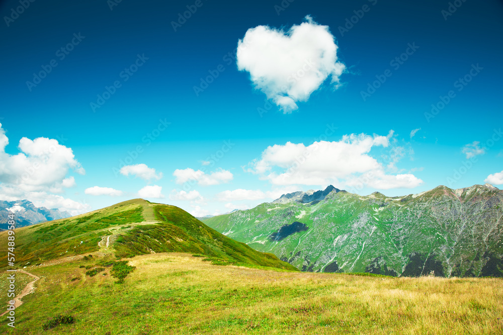 Fototapeta premium Caucasus mountains. Abkhazia. Heart from cloud in the blue sky. Nature Landscape