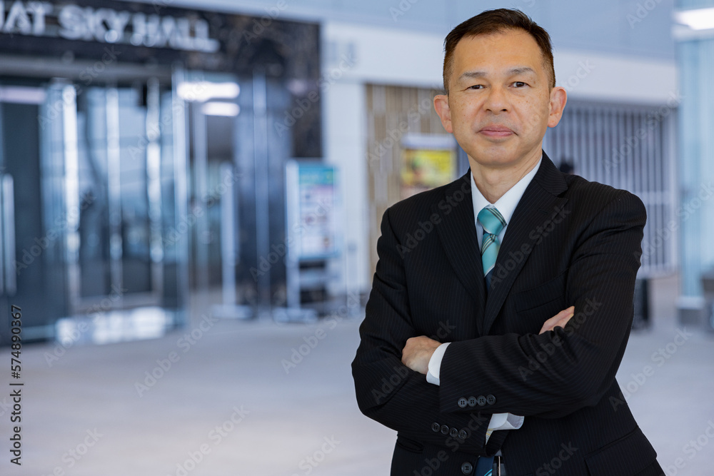 Asian middle-class businessman heading for an overseas business trip in the airport lobby. Asian middle-class businessman heading for an overseas business trip in the airport lobby.