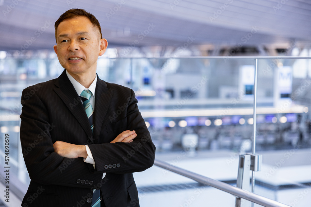 Asian middle-class businessman heading for an overseas business trip in the airport lobby. Asian middle-class businessman heading for an overseas business trip in the airport lobby.
