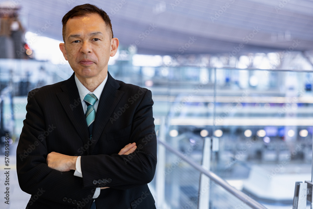 Asian middle-class businessman heading for an overseas business trip in the airport lobby. Asian middle-class businessman heading for an overseas business trip in the airport lobby.