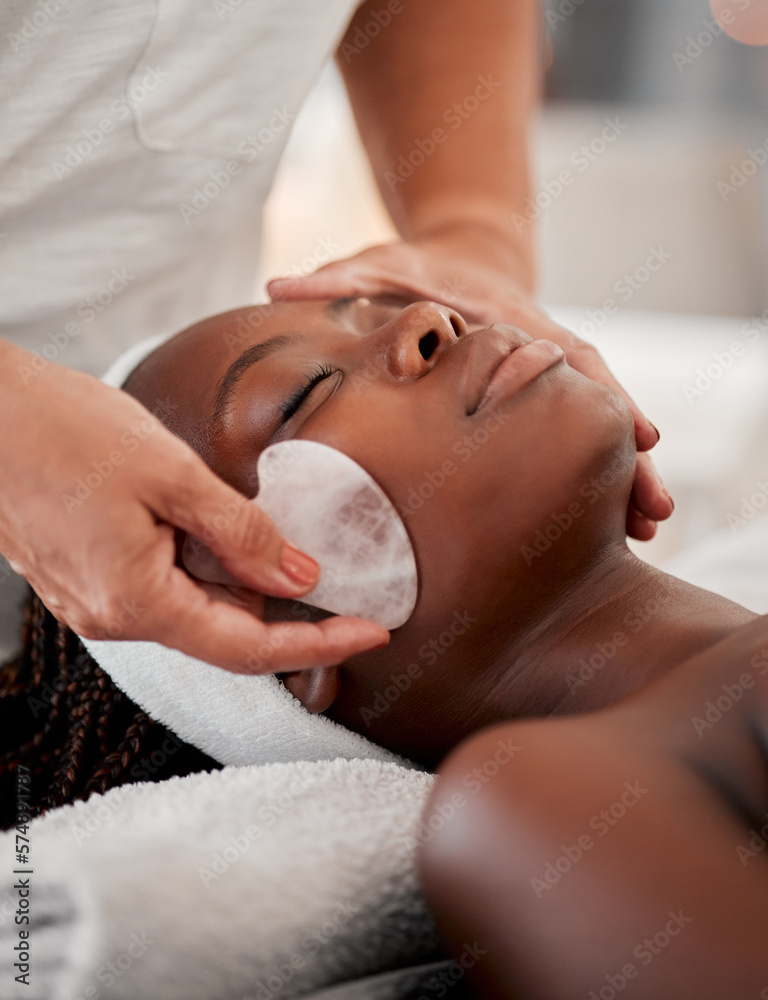 Black woman face, relax and gua sha stone spa treatment of a young female  with facial.