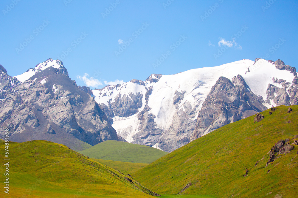 Fototapeta premium Beautiful nature of rocky mountains and peaks with glaciers. Unusual landscape of nature. Rocks on the background of the sky with clouds. Bad weather cyclone, rainy season, foggy day.