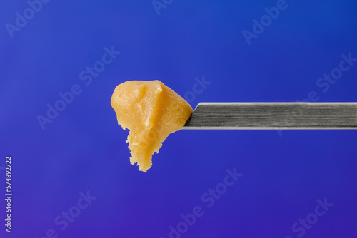 Live Rosin on a dab tool with a blue background photo