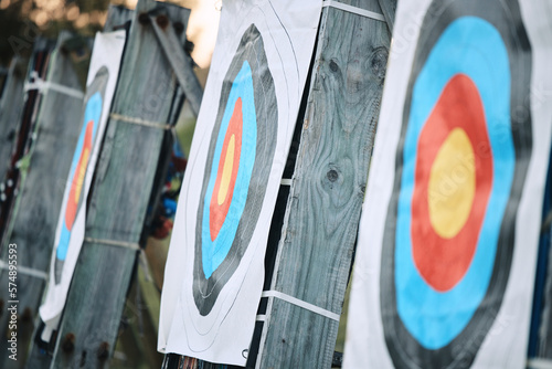 Bullseye target paper, outdoor and field at shooting range for weapon training, aim and accuracy. Sports, archery and poster for gun, bow and arrow at academy for police, army or security for goal photo