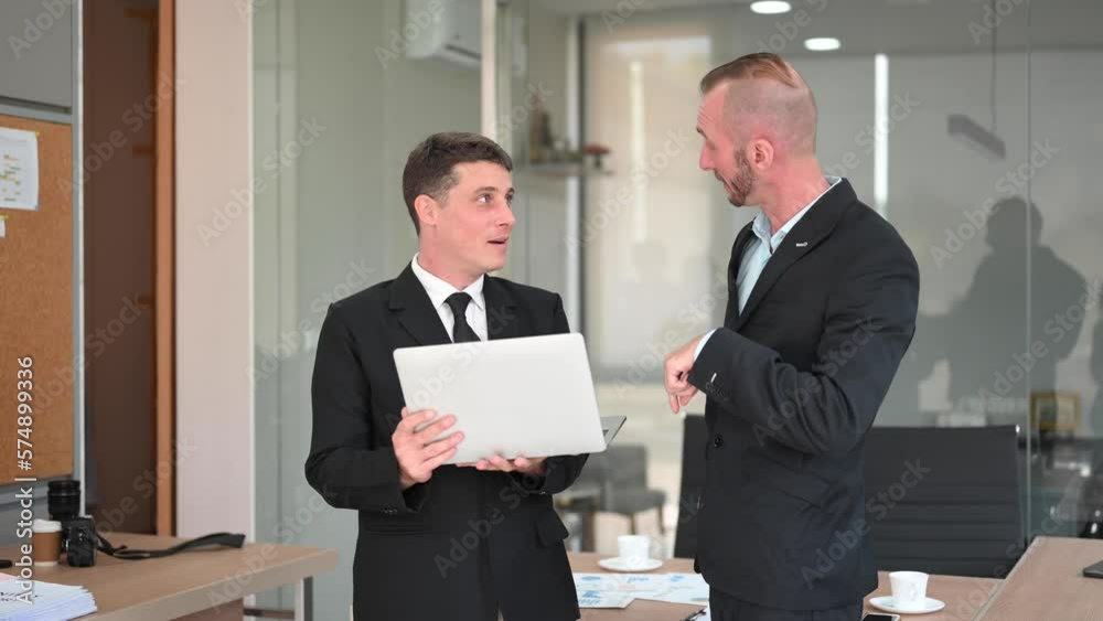 Kind leader executive manager share and discuss business solutions plan ideas on tablet with male marketing manager in modern office.. Kind leader executive manager share and discuss business solutions plan ideas on tablet with male marketing manager in modern office..