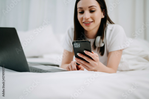 Beautiful woman resting and watching movie in bed at bedroom in morning Lifestyle at home