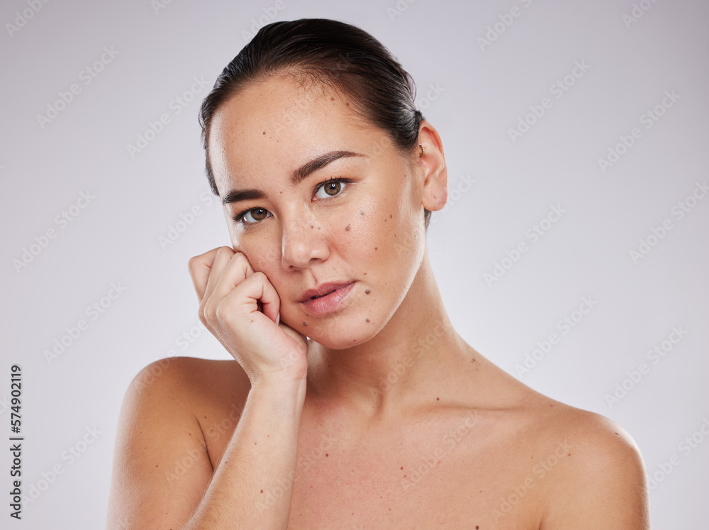 Skincare, face and portrait of a woman in studio for beauty, dermatology and cosmetics for skin glow. Aesthetic asian model person with hand for makeup, mole and facial self care on grey background Skincare, face and portrait of a woman in studio for beauty, dermatology and cosmetics for skin glow. Aesthetic asian model person with hand for makeup, mole and facial self care on grey background