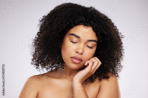 Skincare, cosmetics and black woman with eyes closed and hand on face, afro and advertising luxury makeup product promo. Dermatology, beauty and facial care on model isolated on studio background.