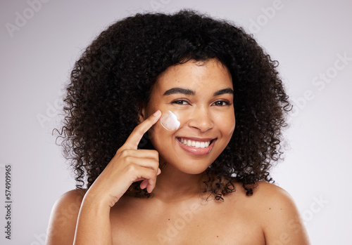 Skincare, cream and portrait of black woman for beauty, wellness and skin health in studio. Dermatology, luxury spa and happy girl with face moisturizer for anti aging, cosmetics and facial treatment