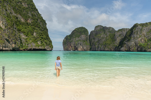Woman walking on the lonely beach of maya bay photo
