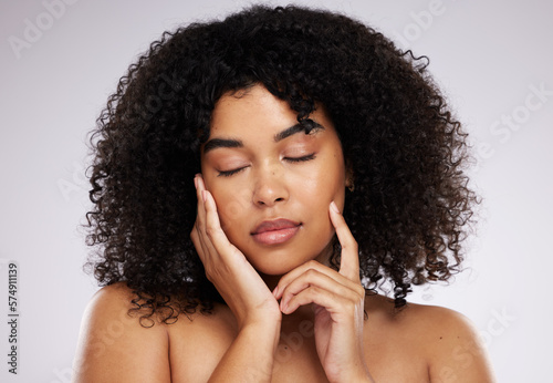 Dermatology, cosmetics and black woman with eyes closed, hand on face and afro, advertising luxury makeup. Skincare, beauty and facial skin care product promo on model isolated on studio background.
