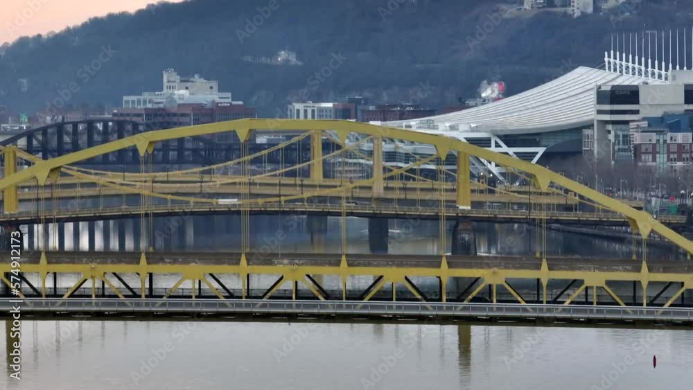 Aerial rising shot of yellow steel bridges in Pittsburgh PA. David Lawrence convention center in city in background. Long aerial zoom. Aerial rising shot of yellow steel bridges in Pittsburgh PA. David Lawrence convention center in city in background. Long aerial zoom.