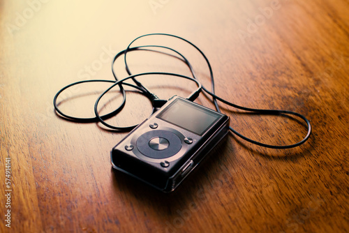 Music mp3 player on a wooden desk. photo
