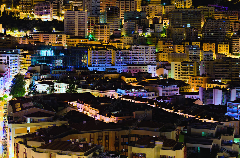 Aerial nightlight landscape of residential buildings in Monaco. Illuminated colorful buildings. Principality of Monaco, buildings, downtown, French Riviera